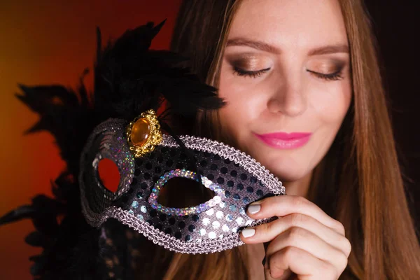 Sensual lady holding carnival mask. — Stock Photo, Image