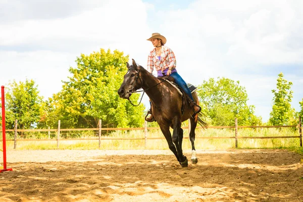 Cowgirl doen paard rijden op platteland weide — Stockfoto