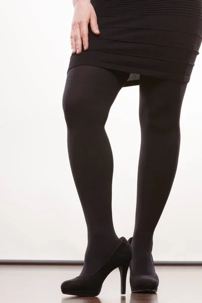 Female legs in black pantyhose heeled shoes — Stock Photo, Image