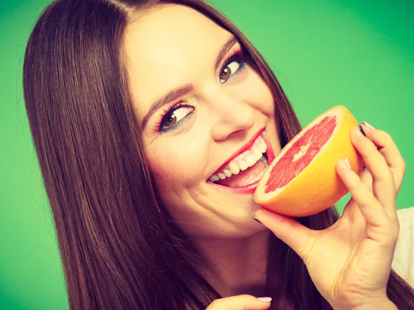 Mulher segura metade da fruta cítrica de toranja na mão — Fotografia de Stock