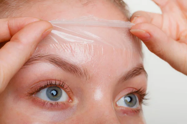 Woman removing facial peel off mask closeup — Stock Photo, Image