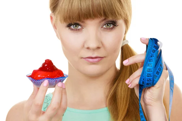 Woman holds cupcake trying to resist temptation — Stock Photo, Image