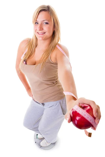 Happy blonde woman holding apple and measuring tape — Stock Photo, Image