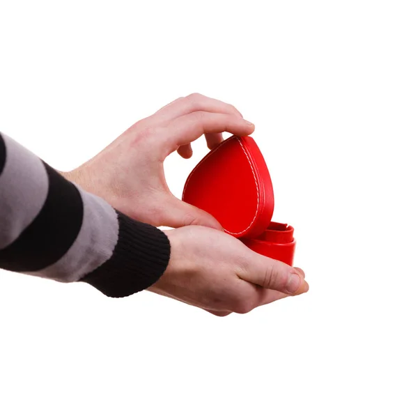 Man holds heart shaped gift box in hand — Stock Photo, Image