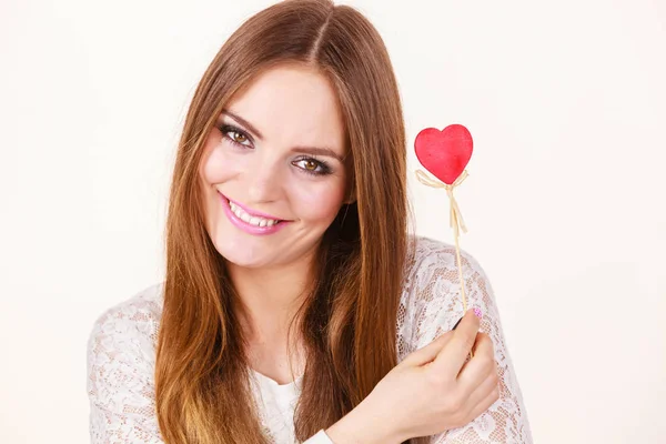 Beautiful woman holding heart shaped hand stick — Stock Photo, Image