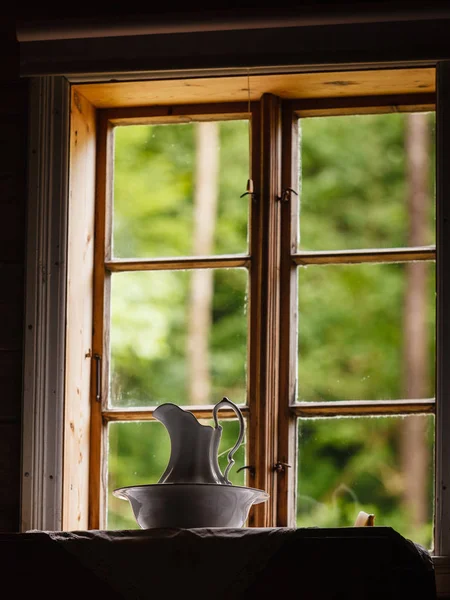 Old vintage window, ceramic jug in foreground — Stock Photo, Image