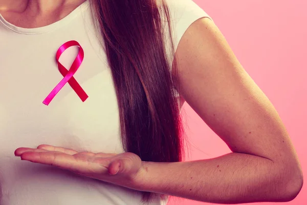 Pink ribbon on woman chest to support breast cancer cause — Stock Photo, Image