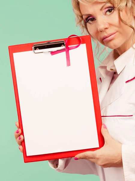 Female doctor with folder and pink ribbon — Stock Photo, Image