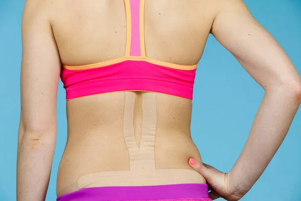 Woman with medical kinesio taping on back — Stock Photo, Image