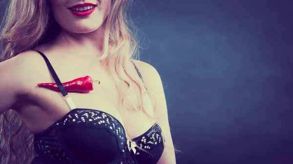 Woman wearing lingerie holding chilli pepper — Stock Photo, Image