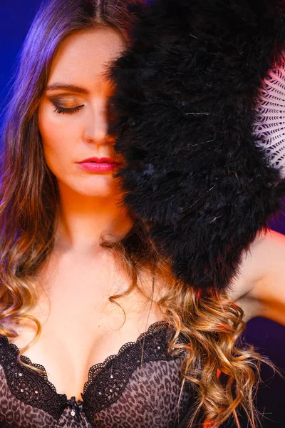 Woman holds carnival black feather fan in hand — Stock Photo, Image