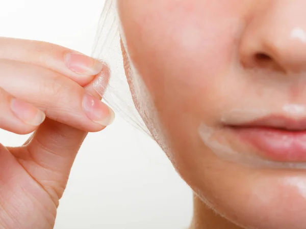 Woman removing facial peel off mask closeup — Stock Photo, Image