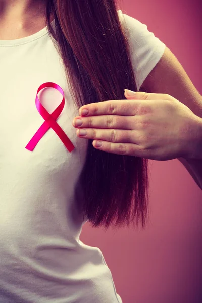 Pink ribbon on woman chest to support breast cancer cause — Stock Photo, Image