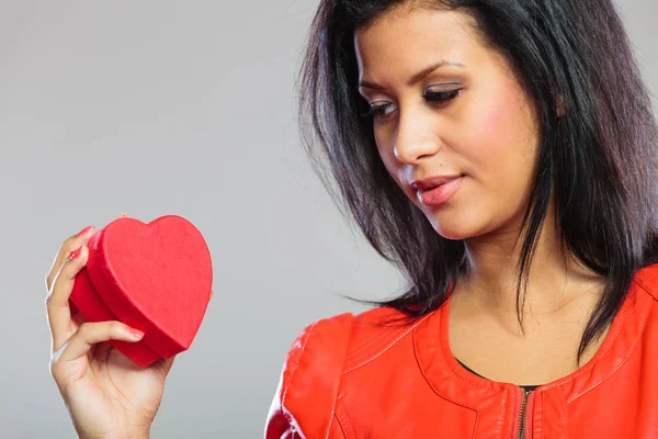 Girl in red holding heart gift — Stock Photo, Image