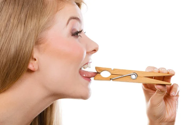 Blonde woman having tongue in clothespin — Stock Photo, Image