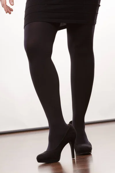 Female legs in black pantyhose heeled shoes — Stock Photo, Image