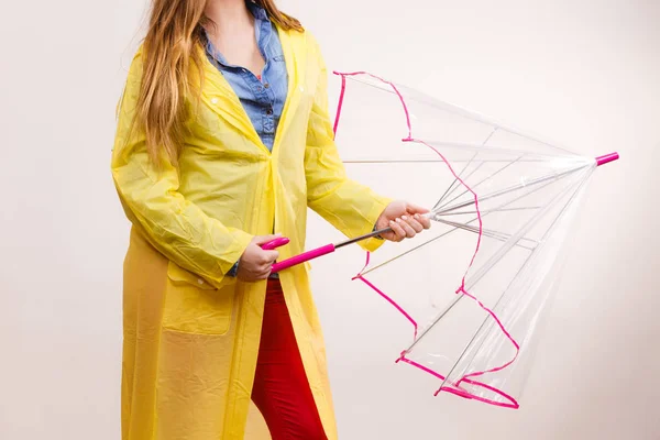 Woman wearing waterproof coat opening umbrella — Stock Photo, Image