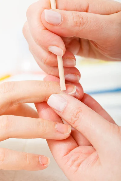 Preparing nails before manicure, pushing back cuticles — Stock Photo, Image