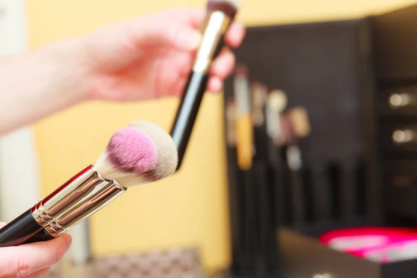 Person holding makeup brushes for blush and powder — Stock Photo, Image