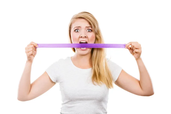 Attractive blonde woman biting tape on mouth. — Stock Photo, Image