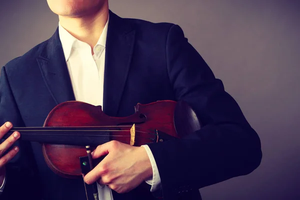 Mies pukeutunut tyylikkäästi pitämällä viulu — kuvapankkivalokuva