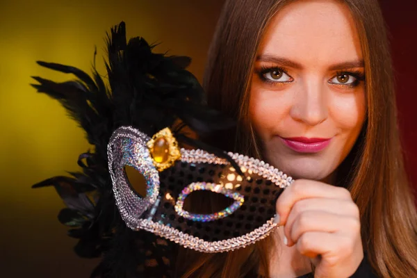 Sensual lady holding carnival mask. — Stock Photo, Image