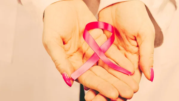 Female hands with pink ribbon — Stock Photo, Image