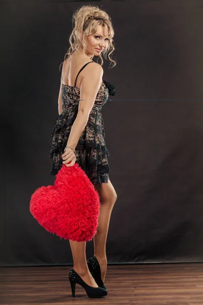 Mature woman holds big red heart — Stock Photo, Image