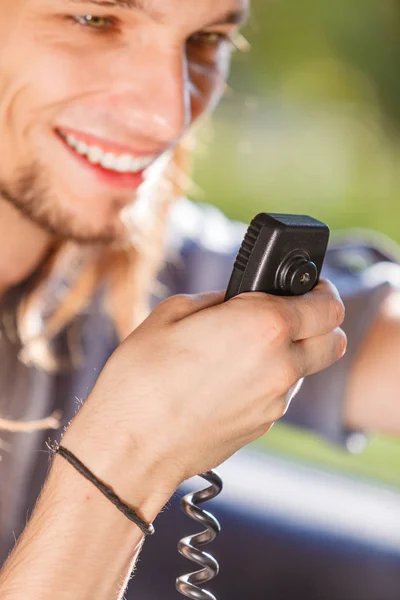 Young man driving car using cb radio — Stock Photo, Image