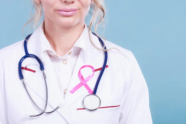 Pink ribbon with stethoscope on medical uniform. — Stock Photo, Image