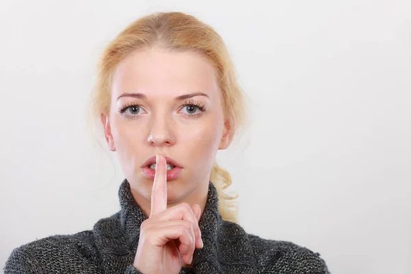 Woman holding finger close to lips, silence — Stock Photo, Image