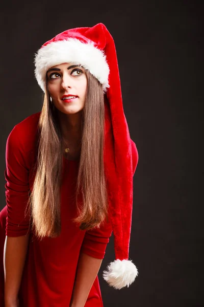 Woman wearing santa claus hat on black — Stock Photo, Image