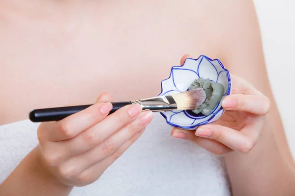 Woman mixing face mask in little porcelain bowl — Stock Photo, Image