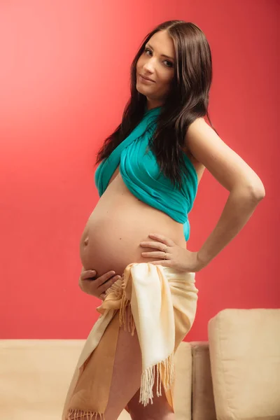 Attractive pregnant woman touching her belly — Stock Photo, Image