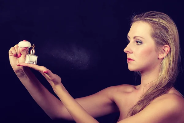 Beautiful woman with holding and applying perfume — Stock Photo, Image