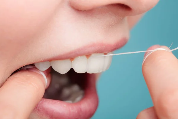 Side view woman face smiling with dental floss. — Stock Photo, Image