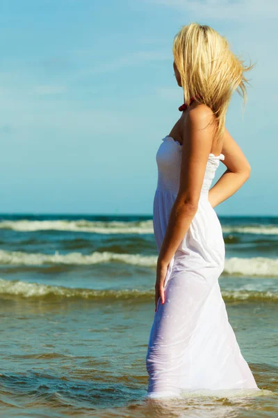 Blonde Frau trägt Kleid, das im Wasser läuft — Stockfoto