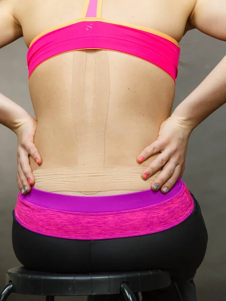 Woman with medical kinesio taping on back — Stock Photo, Image