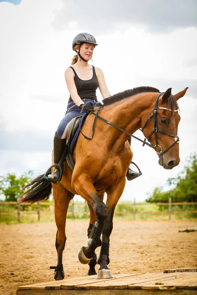 Jockey girl doing horse riding on countryside meadow — Stock Photo, Image