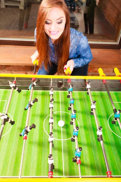 Woman playing table football game — Stock Photo, Image