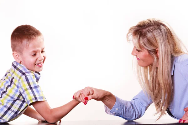 Mother and son arm wrestle sit at table. — Stock Photo, Image