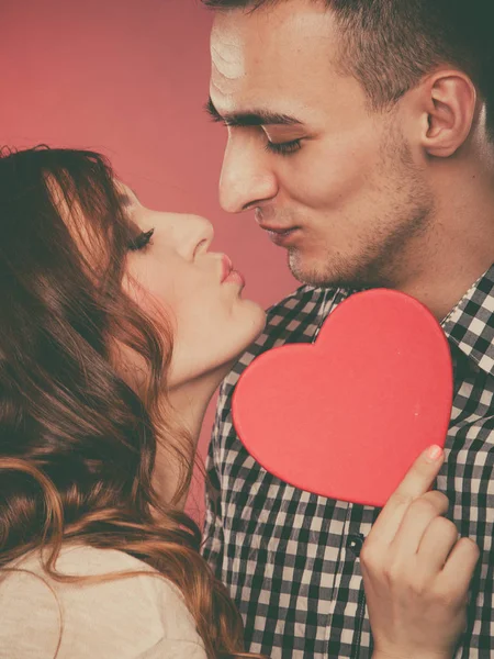 Любящая пара целуется за красным сердцем. Любовь . — стоковое фото
