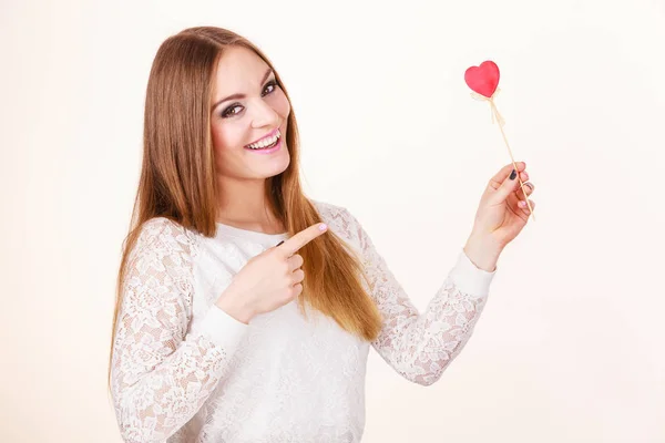 Beautiful woman holding heart shaped hand stick — Stock Photo, Image