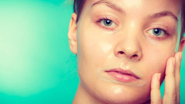 Woman in facial peel off mask. — Stock Photo, Image