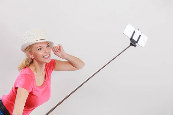 Woman taking picture of herself with phone on stick — Stock Photo, Image