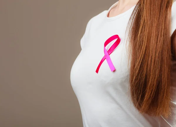 Pink ribbon on woman chest to support breast cancer cause — Stock Photo, Image