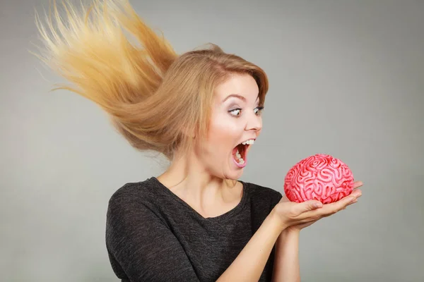 Crazy woman holding brain wanting to eat it — Stock Photo, Image