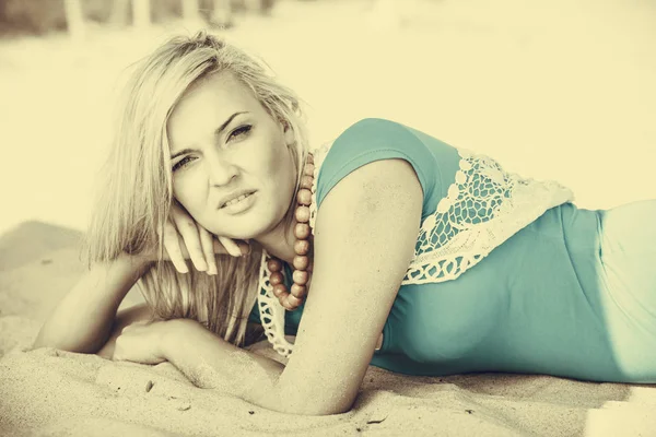 Blonde vrouw liggen op zand. — Stockfoto