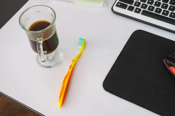 Black dark espresso coffee and toothbrush on table — Stock Photo, Image