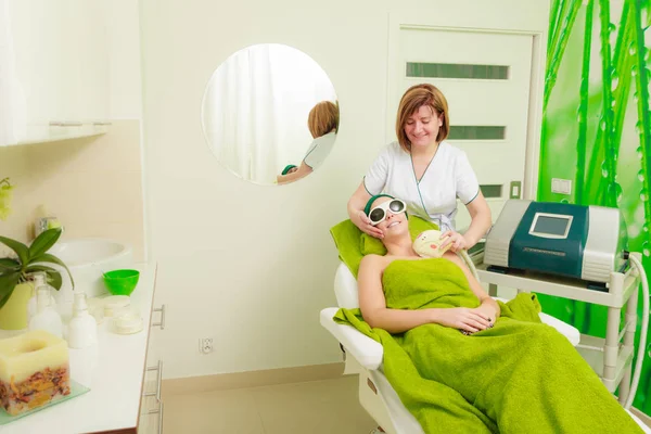Woman getting laser treatment in beautician — Stock Photo, Image